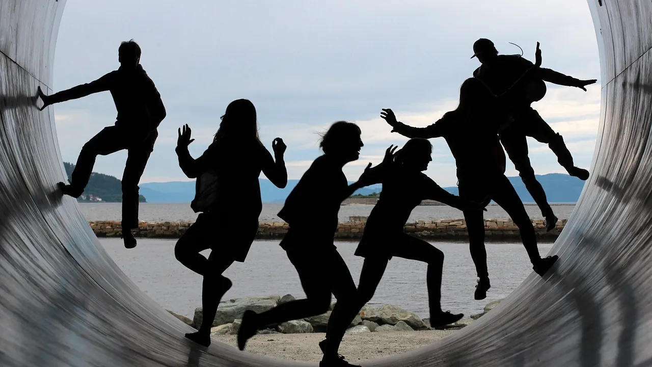 Les silhouettes d’un groupe de personnes en mouvement, cadrées dans un cercle